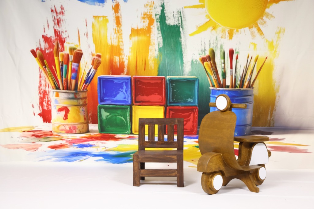 Vibrant creative painting studio set with wooden easel, paint brushes, palette and colorful canvas