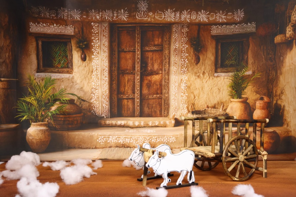Authentic handcrafted wooden bullock cart with white oxen and village backdrop